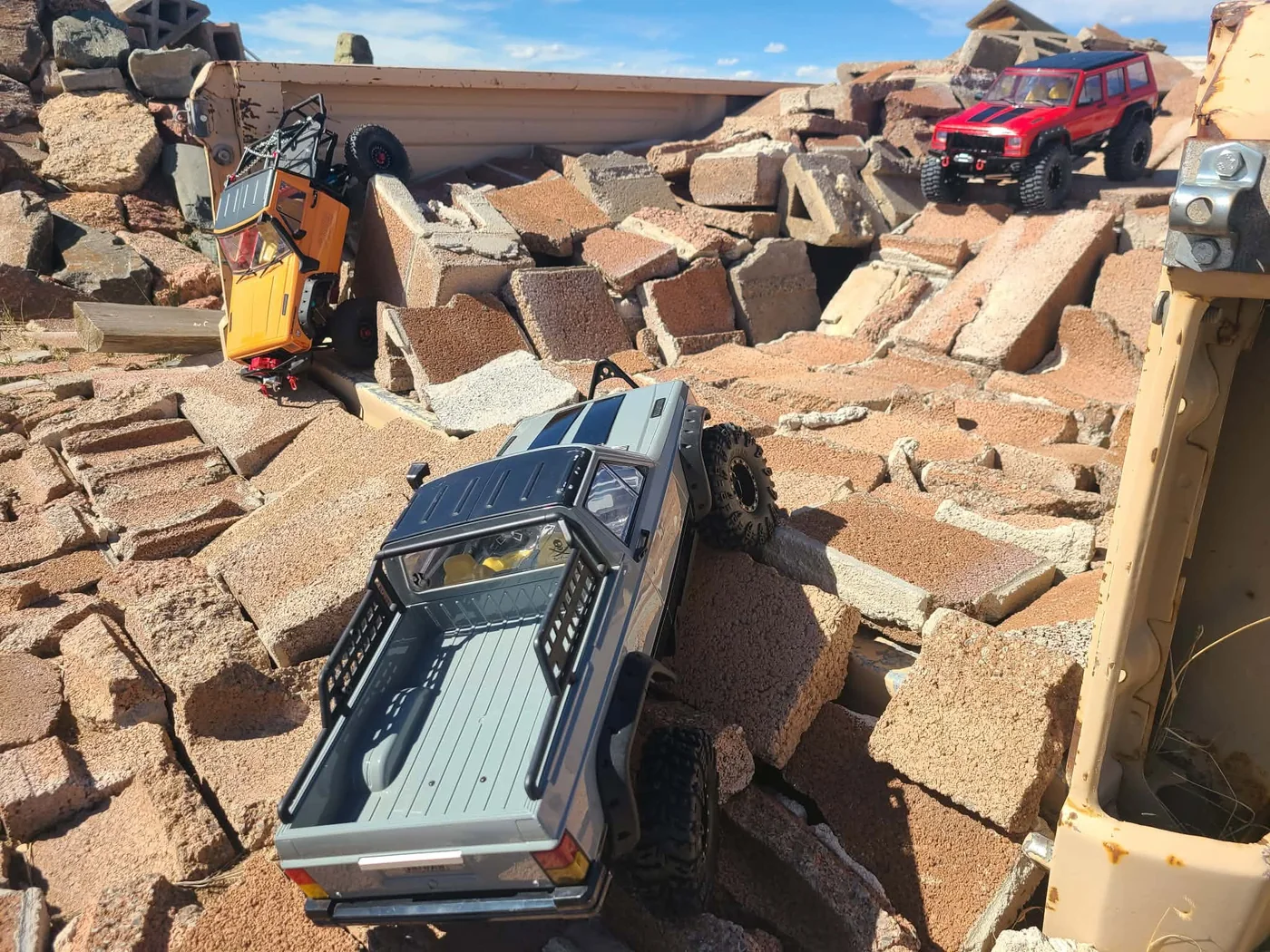 Scale RC crawler trucks navigating a rocky obstacle course